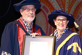 Peter Weir receives his PhD testamur from Deputy Chancellor Rhonda Whitfield